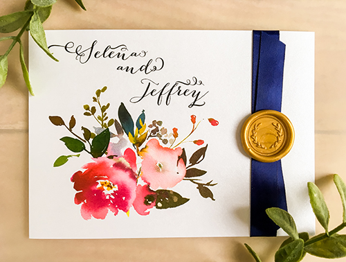 Invitation 2258: This is a bifold wedding invitation with a navy blue ribbon and wax seal on the cover and florals printed on the inside as well as the front of the invitation.