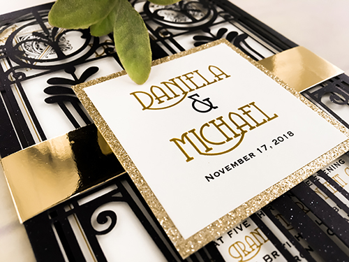 Invitation lc123: Glittering Black, Gold Glitter, White Smooth - This is a glittering black art deco laser cut wedding invitation.  There is a gold mirror belly band with a gold glitter layered cover tag.