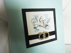 Invitation 915: Blue Aspire Pearl, Black Linen, White Smooth, Devon, Copperplate, Black Ribbon, Brooch/Buckle C