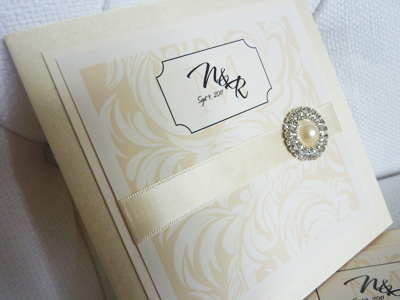 Invitation 923: Buttermilk Pearl, Ivory Pearl, Cream Smooth, The Nauti Gal, Dioscur Swash, Cream Ribbon, Brooch/Buckle G