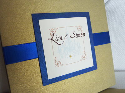 Invitation 932: Gold Pearl, Royal Blue Pearl, Cream Smooth, Aqualine 2, Calligraph 421, Royal Blue Ribbon, Brooch/Buckle Rhinestone