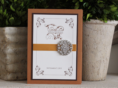 Invitation 938: Cognac, Chocolate Smooth, Cream Smooth, Trajan Pro, Nuncio, Gold Ribbon, Brooch/Buckle X