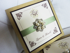 Invitation 939: Gold Pearl, Chocolate Smooth, Cream Smooth, Renaissance, Copperplate, Light Sage Ribbon, Brooch/Buckle T