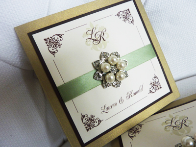 Invitation 939: Gold Pearl, Chocolate Smooth, Cream Smooth, Renaissance, Copperplate, Light Sage Ribbon, Brooch/Buckle T