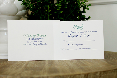 Invitation 1502: This is a navy single pocket invite where the navy pearl paper is folded on the right side to create a pocket which holds the invitation wording card.  A thick emerald ribbon and two navy ribbons are wrapped around the pocket flap.