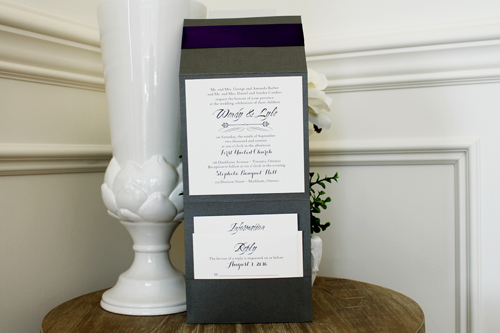 Invitation 1504: This square pocketfold invite has three layers of paper for the cover tag and a thick ribbon pinched behind the tag.  We print on cream paper and the folder is in charcoal pearl.