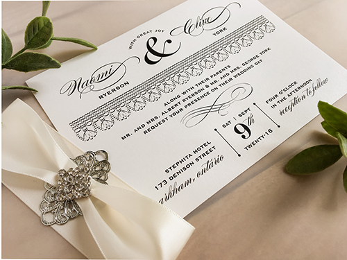 Invitation 1744: Antique Pearl, Antique Pearl, Antique Ribbon, Brooch/Buckle A22, Metal Filigree F2 - Silver - This is a single card antique pearl paper wedding invite with a ribbon and brooch design wrapped around.
