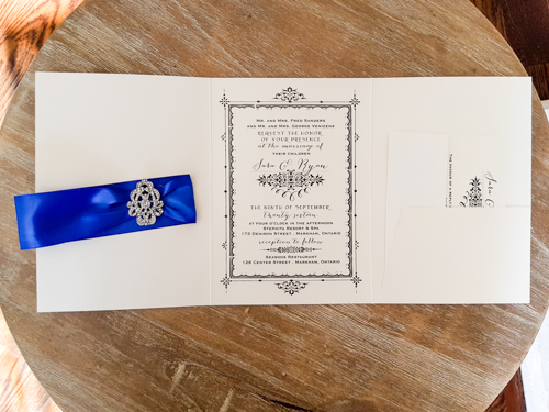 Invitation 1806: White Gold, White Gold, Royal Blue Ribbon, Brooch/Buckle A17 - This is a full cover flap pocketfolder wedding invite in white gold pearl.  There is a royal blue ribbon and brooch design.