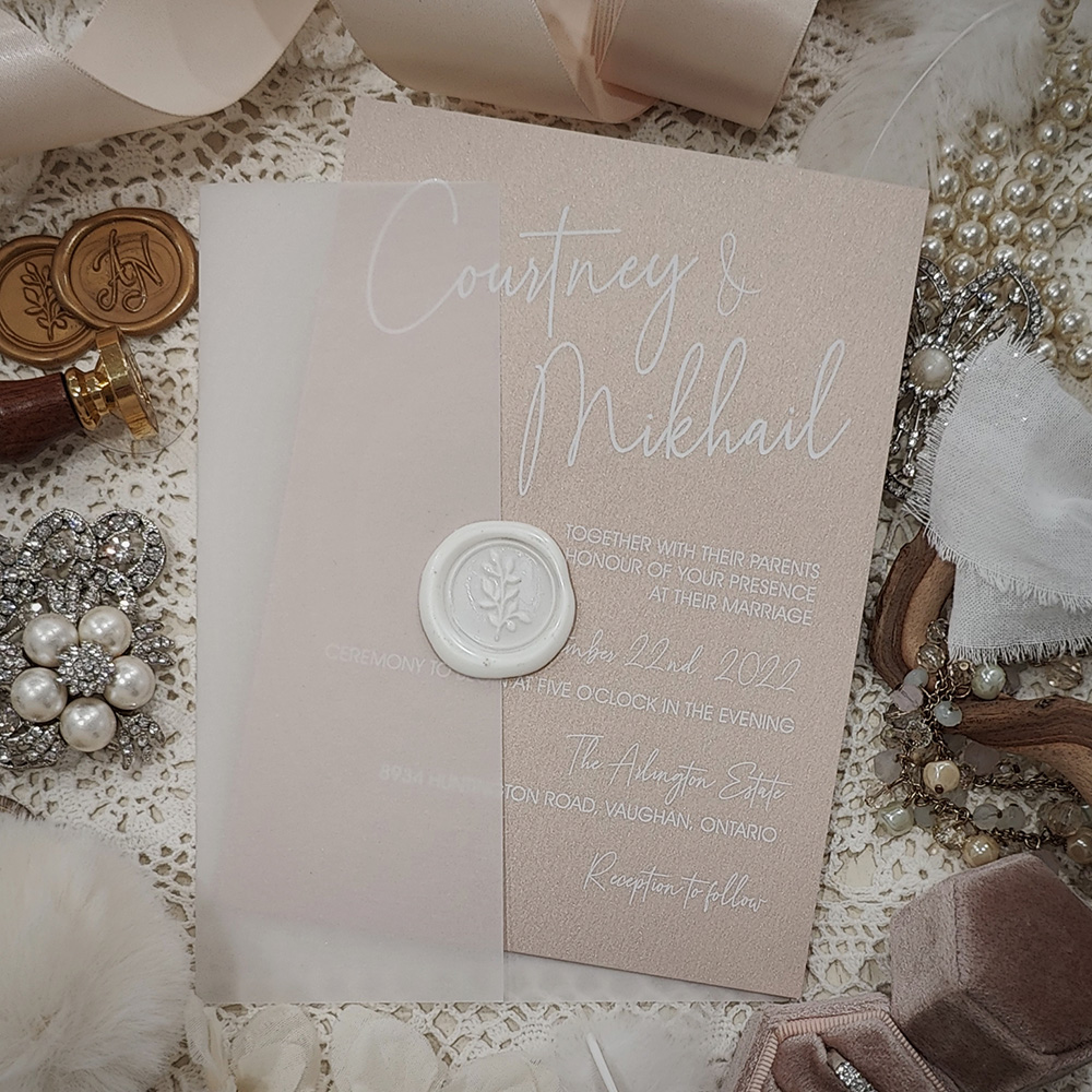 Invitation 3705: Blush Pearl, Ivory Wax - White ink printing on blush pearl paper with clear vellum wrap and ivory wax seal.
