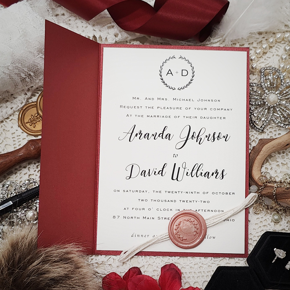 Invitation 3318: Red Lacquer, Cream Smooth, Blush Wax, String Ribbon - Half gate fold wedding invite in a red paper with a string and blush wreath wax seal.