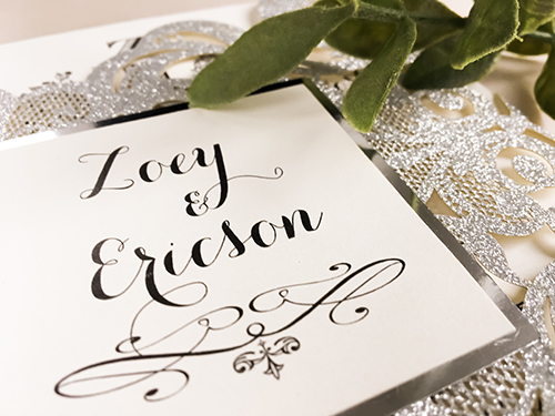 Invitation lc103: Glitter Silver, Silver Mirror, Cream Smooth - This is a silver glitter damask pattern gate fold laser cut wedding invite.  There is a silver mirror layered cover tag.
