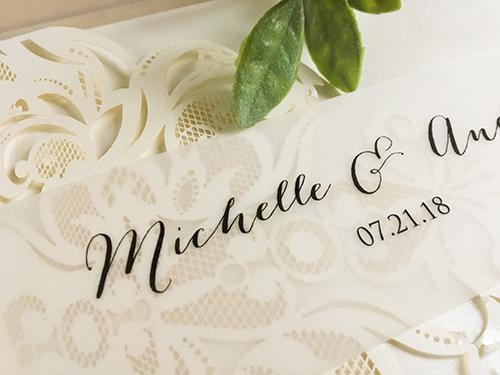 Invitation lc107: Ivory Shimmer, Cream Smooth - This is a ivory shimmer laser cut pocket folder wedding invite.  There is a printed vellum belly band.