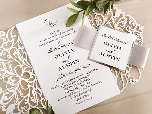 Invitation lc127: White Shimmer, Silver Mirror, White Smooth, Silver Ribbon - This is a white shimmer laser cut wedding invite design.  It is a gate fold with a intricate pattern.  There is a silver ribbon and cover tag.