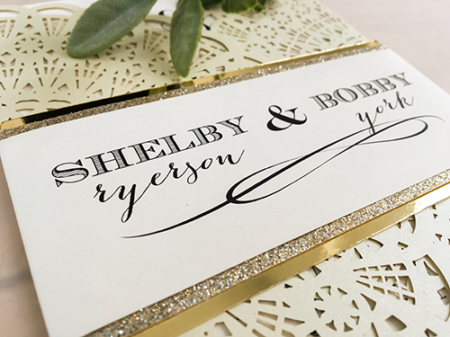 Invitation lc54: This is a cream shimmer fan style laser cut wedding invite.  There is a double layered belly band wrapped around with champagne glitter and gold mirror.