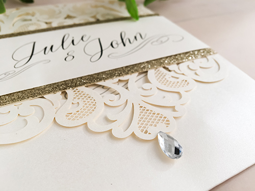 Invitation lc58: Ivory Shimmer, Champagne Glitter, Cream Smooth - This is an ivory shimmer pocket style laser cut wedding invite.  There is a champagne glitter layered belly band.