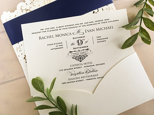 Invitation lc64: Ivory Shimmer, Silver Mirror, Cream Smooth, Brooch/Buckle Rhinestone - This is an ivory shimmer pocket style laser cut wedding invitation.  There is a navy ribbon with a silver mirror layered cover tag design on the flap.