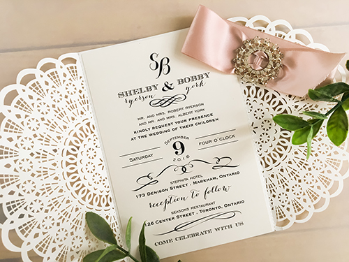 Invitation lc67: Ivory Shimmer, Deep Blush Ribbon, Brooch/Buckle R - This is a fan pattern laser cut wedding invitation in the ivory shimmer color.  There is a deep blush ribbon woven into the brooch design.