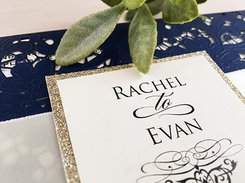 Invitation lc83: Glittering Navy, Cream Smooth, Antique Ribbon - This is a glittering navy pocket style laser cut wedding invitation.  There is a flat antique ribbon with champagne glitter layered cover tag.