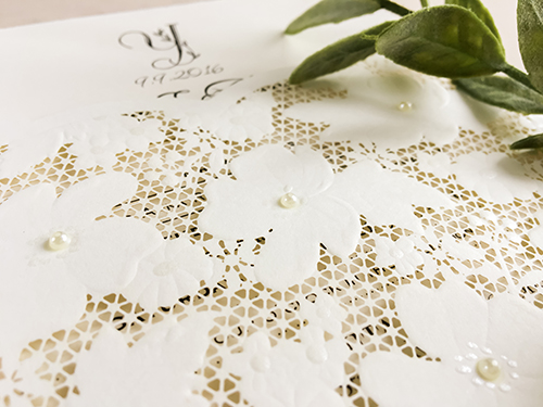 Invitation lc86: White, Cream Smooth - This is a laser cut pocket style wedding invitation.  There is a lace pattern on the pocket.