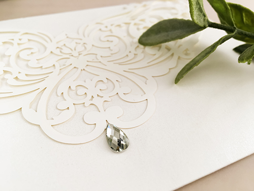 Invitation lc90: Ivory Shimmer - This is a simple ivory shimmer laser cut wedding invitation.  There is a rhinestone jewel on the cover.