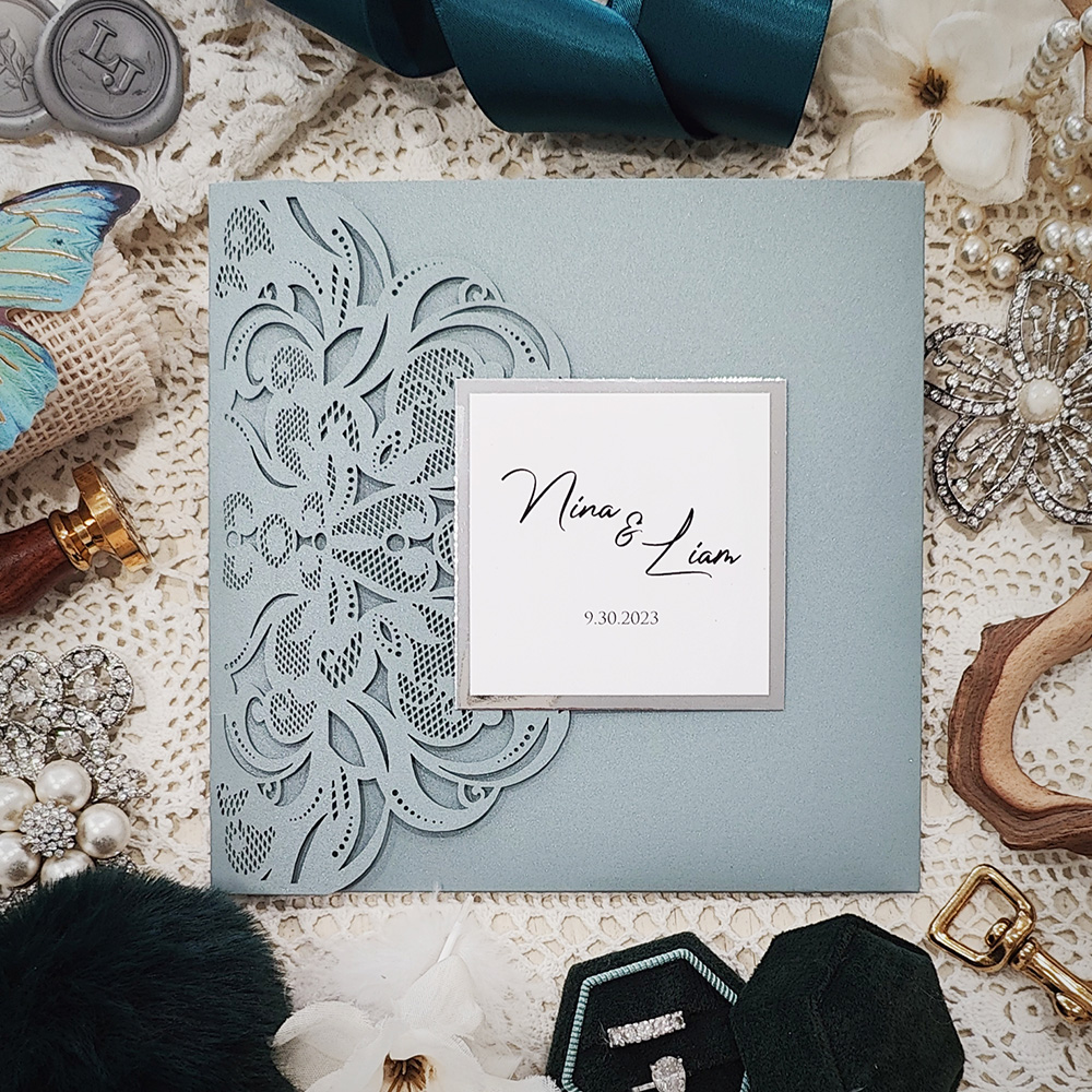 Invitation 8028: Dusty Blue Shimmer, Silver Mirror, Cream Smooth - Square dusky blue pocketfold lasercut with layered tag