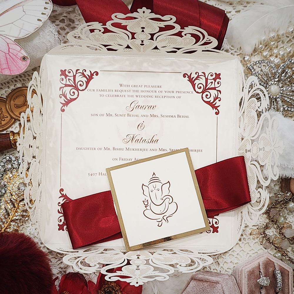Invitation 8100: Ivory Shimmer, Gold Mirror, Cream Smooth, Sherry Ribbon - Four flap Hindu lasercut ivory shimmer with sherry ribbon and layered tag