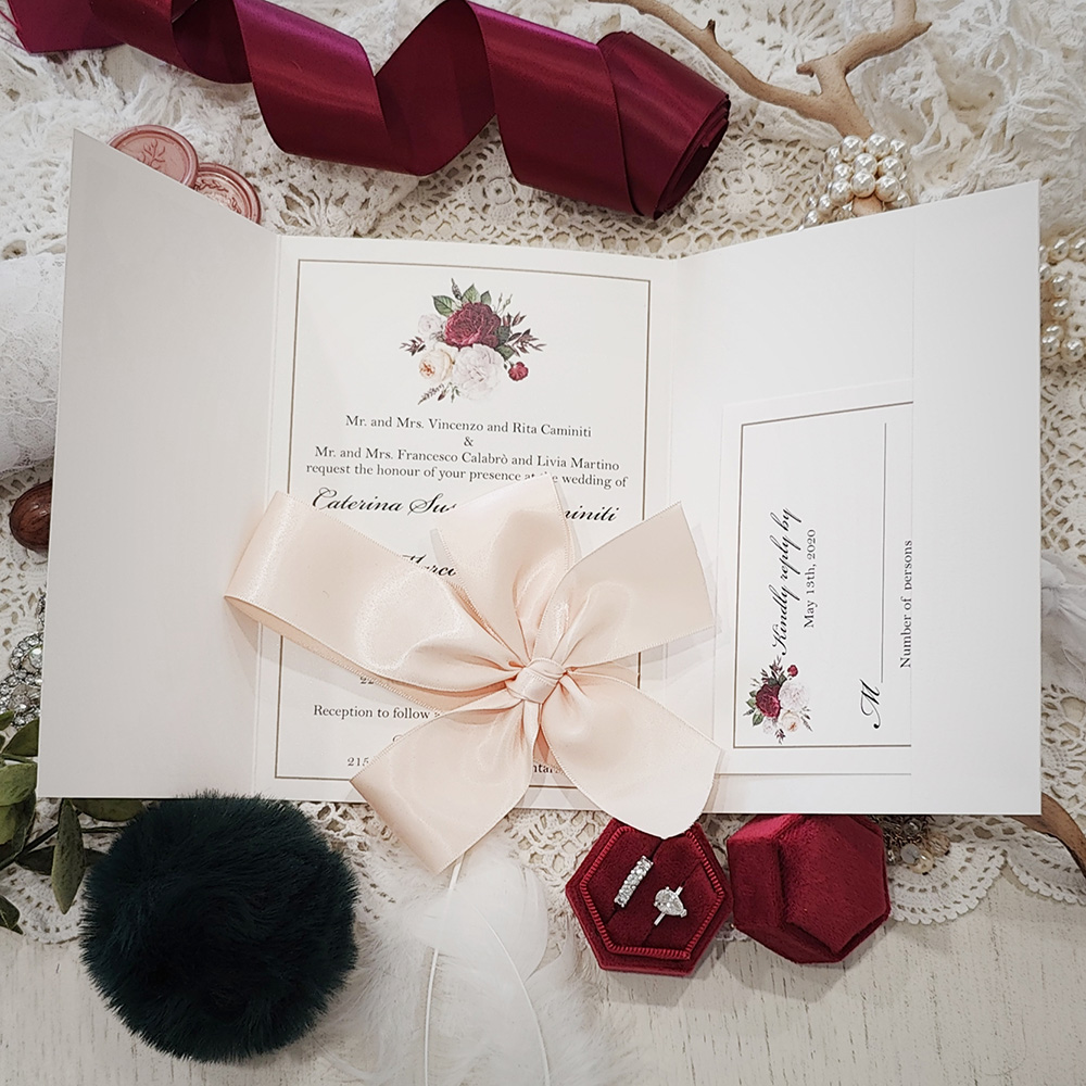 Invitation 3107: Antique Pearl, Blush Ribbon - Pocketfold wedding invitation on an antique pearl paper with a blush bow tied around.