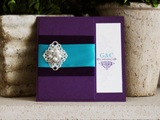 Invitation 779: Purple Pearl, Cream Smooth, Embassy, High Tower, Purple Ribbon, Teal Ribbon, Brooch/Buckle A21, Metal Filigree F2 - Silver