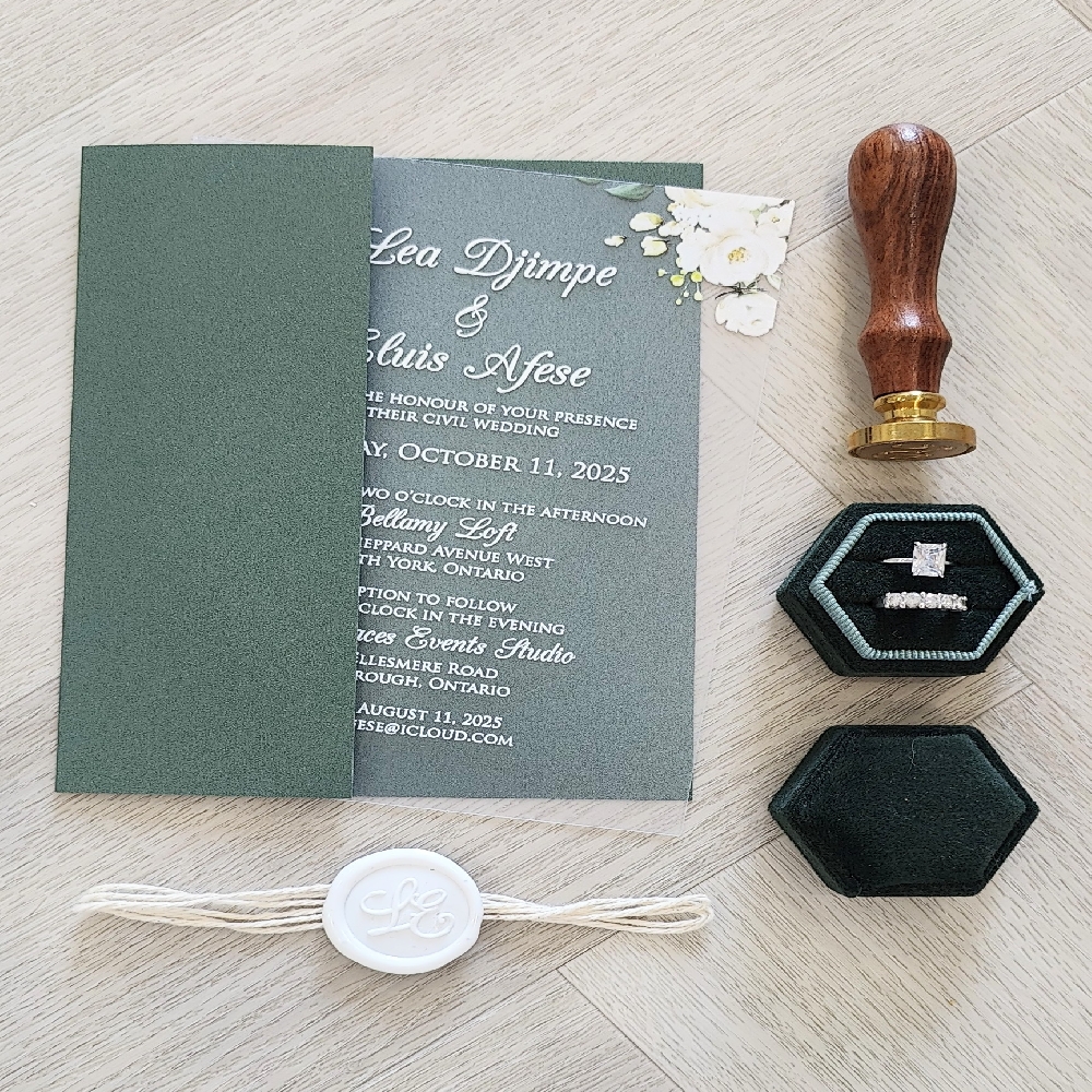 Clear Acrylic invite inside a emerald green gate fold with string and ivory wax seal embellishment.