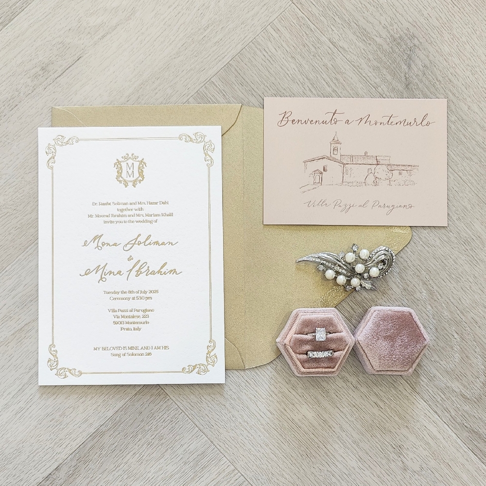 This is a gold foil stamped pressed wedding invitation on a thick white cotton paper.  There is a nice border design element surrounding the layout, along with a custom monogram design at the top.  There is a blush pearl insert that depicts that venue that the wedding is being held.  All of these cards are placed inside a metallic gold envelope.
This wedding took place at Villa Pazzi in Italy.
Villa Pazzi in Italy is a truly enchanting wedding venue, perfect for couples dreaming of a romantic Tuscan celebration. Formally known as Villa di Maiano (sometimes called Villa Pazzi di Maiano), it’s located just outside Florence, offering sweeping views over the Tuscan hills, olive groves, and vineyards. The villa is a historic estate with Renaissance architecture, grand halls, elegant gardens, and terraces that set a magical backdrop for ceremonies and receptions.
Couples often choose Villa Pazzi for its versatility—it allows for an outdoor garden ceremony with Florence in the distance, followed by a refined indoor or courtyard reception. The estate features frescoed ballrooms, rustic yet luxurious settings, and traditional Tuscan cuisine that can be paired with local wines. Many wedding planners in Florence are familiar with the villa, so coordination and logistics (like music, décor, and accommodations) are seamless. Because of its history and exclusivity, it’s an ideal choice for luxury weddings or destination events with a true “Italian villa” atmosphere. This is a gold foil stamped pressed wedding invitation on a thick white cotton paper.  There is a nice border design element surrounding the layout, along with a custom monogram design at the top.  There is a blush pearl insert that depicts that venue that the wedding is being held.  All of these cards are placed inside a metallic gold envelope.
This wedding took place at Villa Pazzi in Italy.
Villa Pazzi in Italy is a truly enchanting wedding venue, perfect for couples dreaming of a romantic Tuscan celebration. Formally known as Villa di Maiano (sometimes called Villa Pazzi di Maiano), it’s located just outside Florence, offering sweeping views over the Tuscan hills, olive groves, and vineyards. The villa is a historic estate with Renaissance architecture, grand halls, elegant gardens, and terraces that set a magical backdrop for ceremonies and receptions.
Couples often choose Villa Pazzi for its versatility—it allows for an outdoor garden ceremony with Florence in the distance, followed by a refined indoor or courtyard reception. The estate features frescoed ballrooms, rustic yet luxurious settings, and traditional Tuscan cuisine that can be paired with local wines. Many wedding planners in Florence are familiar with the villa, so coordination and logistics (like music, décor, and accommodations) are seamless. Because of its history and exclusivity, it’s an ideal choice for luxury weddings or destination events with a true “Italian villa” atmosphere.