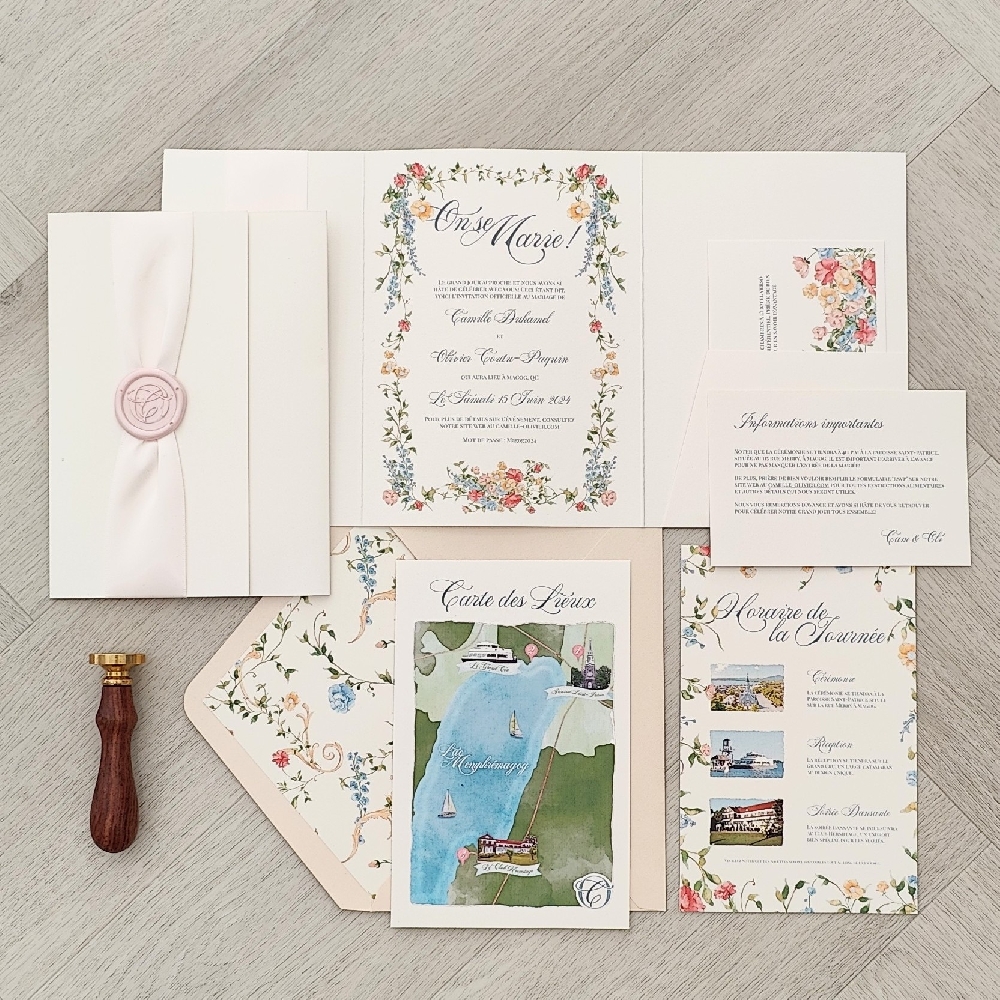 This is a pocketfold wedding invitation printed on an ivory paper.  There is a custom floral pattern printed on all the layouts to have a matching suite throughout.  There is a pocket on the inside that will hold multiple inserts from the RSVP card, map and more details about the wedding.  The cover of the trifold has a ivory ribbon and a custom blush wax seal monogram embellishment.  The invitations are paired with a blush pearl envelope that has a matching floral envelope liner.
This wedding took place in Quebec, Canada.
Weddings in Quebec offer a romantic blend of European charm and Canadian natural beauty. Whether you’re envisioning a classic city celebration or a countryside escape, Quebec provides countless stunning settings. In Montreal, couples can host elegant weddings in historic hotels, modern lofts, or chic rooftop venues with skyline views. Quebec City, with its cobblestone streets, centuries-old architecture, and the iconic Château Frontenac, is often compared to Paris for its timeless atmosphere — making it one of Canada’s most romantic wedding destinations. Beyond the cities, regions like the Laurentians and Eastern Townships feature charming inns, vineyards, and lakeside resorts perfect for outdoor or rustic-chic weddings surrounded by nature.
Quebec weddings also reflect a mix of French-Canadian culture and contemporary flair. Couples can incorporate gourmet French-inspired cuisine, fine wines, and live music to create an unforgettable experience for guests. Many venues offer bilingual services (English and French), luxurious accommodations, and wedding packages that make planning seamless. Whether it’s a winter wedding in a cozy chalet or a summer celebration overlooking the St. Lawrence River, Quebec provides a magical backdrop for couples seeking elegance, culture, and romance in one destination. This is a pocketfold wedding invitation printed on an ivory paper.  There is a custom floral pattern printed on all the layouts to have a matching suite throughout.  There is a pocket on the inside that will hold multiple inserts from the RSVP card, map and more details about the wedding.  The cover of the trifold has a ivory ribbon and a custom blush wax seal monogram embellishment.  The invitations are paired with a blush pearl envelope that has a matching floral envelope liner.
This wedding took place in Quebec, Canada.
Weddings in Quebec offer a romantic blend of European charm and Canadian natural beauty. Whether you’re envisioning a classic city celebration or a countryside escape, Quebec provides countless stunning settings. In Montreal, couples can host elegant weddings in historic hotels, modern lofts, or chic rooftop venues with skyline views. Quebec City, with its cobblestone streets, centuries-old architecture, and the iconic Château Frontenac, is often compared to Paris for its timeless atmosphere — making it one of Canada’s most romantic wedding destinations. Beyond the cities, regions like the Laurentians and Eastern Townships feature charming inns, vineyards, and lakeside resorts perfect for outdoor or rustic-chic weddings surrounded by nature.
Quebec weddings also reflect a mix of French-Canadian culture and contemporary flair. Couples can incorporate gourmet French-inspired cuisine, fine wines, and live music to create an unforgettable experience for guests. Many venues offer bilingual services (English and French), luxurious accommodations, and wedding packages that make planning seamless. Whether it’s a winter wedding in a cozy chalet or a summer celebration overlooking the St. Lawrence River, Quebec provides a magical backdrop for couples seeking elegance, culture, and romance in one destination.