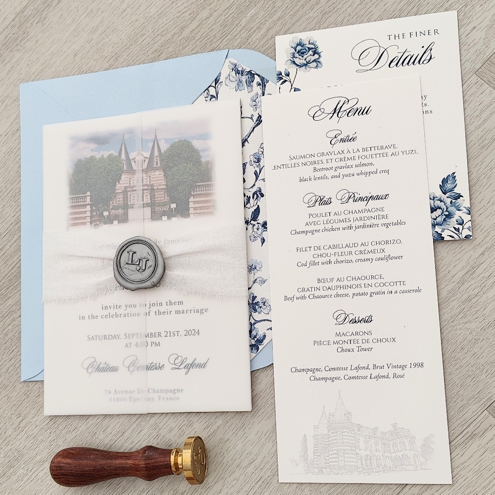 This is a destination wedding invitation card that is printed on a off white paper.  There is a full vellum enclosure wrapped around the card along with a off-white lace and silver custom monogram wax seal embellishment.  On the layout, there is a venue image printed at the top of the layout.   The invitations are paired with an azure blue envelope with a custom floral print envelope liner that also matches the RSVP card insert.  There is also a matching simple menu card that the couple used for the wedding.
This destination wedding took place at Chateau Contesse Lafond in France.
A wedding at Château Comtesse Lafond in France is the epitome of romance, elegance, and French sophistication. Located in Épernay, in the heart of the world-famous Champagne region, this enchanting château is surrounded by lush vineyards and offers breathtaking views of the countryside. The estate is renowned for its historic architecture, refined interiors, and exclusive ambiance, making it an ideal venue for couples seeking a fairy-tale wedding in France.
Couples can exchange vows in the château’s manicured gardens or elegant salons, followed by a champagne reception featuring the estate’s own Comtesse Lafond Champagne — a signature touch that adds authenticity and luxury to the celebration. The venue offers beautifully appointed spaces for both intimate gatherings and grand receptions, with gourmet French cuisine and fine wines enhancing the experience. The combination of romantic vineyards, rich heritage, and impeccable service creates an unforgettable atmosphere for both local and destination weddings.
Many couples also take advantage of the château’s proximity to Reims and Paris, making travel convenient for international guests. With its timeless charm and world-class Champagne, Château Comtesse Lafond is a dream setting for couples looking to celebrate love in true French style. This is a destination wedding invitation card that is printed on a off white paper.  There is a full vellum enclosure wrapped around the card along with a off-white lace and silver custom monogram wax seal embellishment.  On the layout, there is a venue image printed at the top of the layout.   The invitations are paired with an azure blue envelope with a custom floral print envelope liner that also matches the RSVP card insert.  There is also a matching simple menu card that the couple used for the wedding.
This destination wedding took place at Chateau Contesse Lafond in France.
A wedding at Château Comtesse Lafond in France is the epitome of romance, elegance, and French sophistication. Located in Épernay, in the heart of the world-famous Champagne region, this enchanting château is surrounded by lush vineyards and offers breathtaking views of the countryside. The estate is renowned for its historic architecture, refined interiors, and exclusive ambiance, making it an ideal venue for couples seeking a fairy-tale wedding in France.
Couples can exchange vows in the château’s manicured gardens or elegant salons, followed by a champagne reception featuring the estate’s own Comtesse Lafond Champagne — a signature touch that adds authenticity and luxury to the celebration. The venue offers beautifully appointed spaces for both intimate gatherings and grand receptions, with gourmet French cuisine and fine wines enhancing the experience. The combination of romantic vineyards, rich heritage, and impeccable service creates an unforgettable atmosphere for both local and destination weddings.
Many couples also take advantage of the château’s proximity to Reims and Paris, making travel convenient for international guests. With its timeless charm and world-class Champagne, Château Comtesse Lafond is a dream setting for couples looking to celebrate love in true French style.