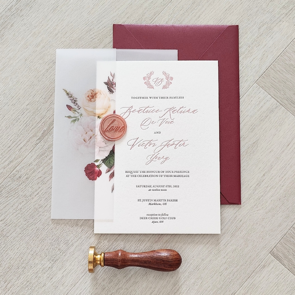 This is a letterpress wedding invitation printed on a white cotton paper with 2 ink colors - blush and black.  There is a full vellum wrap enclosure that has a floral graphic printed.  A gold love wax seal is the final embellishment on the vellum wrap.  There is a burgundy shimmer envelope.
This wedding took place at the Deer Creek Golf club in Ajax, Ontario.
Deer Creek Golf Club in Ajax is one of Durham Region’s most elegant and versatile wedding venues. Surrounded by beautifully manicured golf greens, rolling hills, and serene water features, it offers a picturesque backdrop for both ceremonies and receptions. Couples can choose from several stunning event spaces — including the Loft Ballroom, Heritage Room, and Deer Creek North Clubhouse — each featuring elegant décor, high ceilings, and large windows with panoramic views of the golf course. Outdoor ceremonies on the landscaped terraces or garden areas provide a romantic setting for exchanging vows.
Inside, the venue offers full-service wedding packages with gourmet catering, bar service, and professional event coordination. The culinary team is known for creating exceptional plated dinners and buffets tailored to each couple’s taste. The spacious ballrooms can accommodate both intimate gatherings and large celebrations, while the staff ensures every detail — from décor to timing — runs smoothly. With its combination of natural beauty, modern amenities, and attentive service, Deer Creek Golf Club is a top choice for couples seeking a sophisticated wedding venue in the Greater Toronto Area. This is a letterpress wedding invitation printed on a white cotton paper with 2 ink colors - blush and black.  There is a full vellum wrap enclosure that has a floral graphic printed.  A gold love wax seal is the final embellishment on the vellum wrap.  There is a burgundy shimmer envelope.
This wedding took place at the Deer Creek Golf club in Ajax, Ontario.
Deer Creek Golf Club in Ajax is one of Durham Region’s most elegant and versatile wedding venues. Surrounded by beautifully manicured golf greens, rolling hills, and serene water features, it offers a picturesque backdrop for both ceremonies and receptions. Couples can choose from several stunning event spaces — including the Loft Ballroom, Heritage Room, and Deer Creek North Clubhouse — each featuring elegant décor, high ceilings, and large windows with panoramic views of the golf course. Outdoor ceremonies on the landscaped terraces or garden areas provide a romantic setting for exchanging vows.
Inside, the venue offers full-service wedding packages with gourmet catering, bar service, and professional event coordination. The culinary team is known for creating exceptional plated dinners and buffets tailored to each couple’s taste. The spacious ballrooms can accommodate both intimate gatherings and large celebrations, while the staff ensures every detail — from décor to timing — runs smoothly. With its combination of natural beauty, modern amenities, and attentive service, Deer Creek Golf Club is a top choice for couples seeking a sophisticated wedding venue in the Greater Toronto Area.