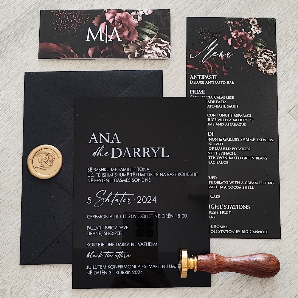 This is a solid black acrylic wedding invite with a printed floral belly band wrapped around the card.  There is a matching wedding menu using the same fonts and graphics from the wedding invite.
This was a destination wedding, as this wedding took place in Albania.
Weddings in Albania are a beautiful blend of rich cultural traditions, lively celebrations, and stunning scenery. Albanian weddings are known for their joyful atmosphere, filled with music, dancing, and vibrant customs that bring families and communities together. Traditional ceremonies can last several days and often include rituals such as the “krushqit” (wedding procession), elaborate feasts, and folk dances accompanied by live music. Guests are treated to generous hospitality, symbolizing the importance of family, unity, and celebration in Albanian culture.
Modern weddings in Albania often take place at elegant venues such as seaside resorts along the Albanian Riviera (in places like Durrës, Vlorë, or Sarandë), chic hotels in Tirana, or picturesque countryside estates near Shkodër and Berat. Many couples choose outdoor ceremonies overlooking the Adriatic or Ionian Seas, offering breathtaking sunset views. Albania has also become a popular destination for international couples looking for a more affordable yet scenic European wedding location — offering luxurious experiences at a fraction of Western European prices. Whether traditional or contemporary, Albanian weddings are full of passion, color, and unforgettable moments. This is a solid black acrylic wedding invite with a printed floral belly band wrapped around the card.  There is a matching wedding menu using the same fonts and graphics from the wedding invite.
This was a destination wedding, as this wedding took place in Albania.
Weddings in Albania are a beautiful blend of rich cultural traditions, lively celebrations, and stunning scenery. Albanian weddings are known for their joyful atmosphere, filled with music, dancing, and vibrant customs that bring families and communities together. Traditional ceremonies can last several days and often include rituals such as the “krushqit” (wedding procession), elaborate feasts, and folk dances accompanied by live music. Guests are treated to generous hospitality, symbolizing the importance of family, unity, and celebration in Albanian culture.
Modern weddings in Albania often take place at elegant venues such as seaside resorts along the Albanian Riviera (in places like Durrës, Vlorë, or Sarandë), chic hotels in Tirana, or picturesque countryside estates near Shkodër and Berat. Many couples choose outdoor ceremonies overlooking the Adriatic or Ionian Seas, offering breathtaking sunset views. Albania has also become a popular destination for international couples looking for a more affordable yet scenic European wedding location — offering luxurious experiences at a fraction of Western European prices. Whether traditional or contemporary, Albanian weddings are full of passion, color, and unforgettable moments.