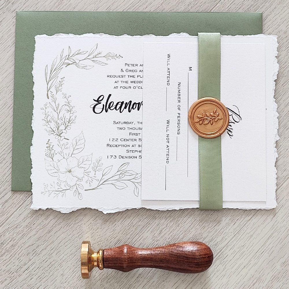 This is a deckled edge wedding invitation on a white paper with a 5/8 light sage green ribbon stripe and gold branch wax seal embellishment.  There is a mid green envelope that is paired with it.  On the invitation layout there is a floral design around the text.
Deckle edge wedding invitations are a stunning choice for couples looking to add a romantic, vintage, or fine-art touch to their stationery. The term “deckle edge” refers to the soft, feathered, and slightly irregular edges of the paper — a look reminiscent of handmade or antique paper. This is a deckled edge wedding invitation on a white paper with a 5/8 light sage green ribbon stripe and gold branch wax seal embellishment.  There is a mid green envelope that is paired with it.  On the invitation layout there is a floral design around the text.
Deckle edge wedding invitations are a stunning choice for couples looking to add a romantic, vintage, or fine-art touch to their stationery. The term “deckle edge” refers to the soft, feathered, and slightly irregular edges of the paper — a look reminiscent of handmade or antique paper.
