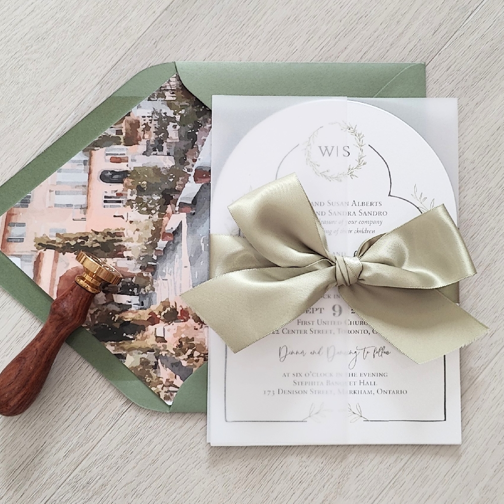 This is an arch shaped wedding card with a full vellum wrap enclosure embellished with a light sage ribbon bow.  The invite is paired with a matching mid green envelope that has a printed design envelope liner depicting where the wedding is taking place.
Envelope liners are one of the easiest ways to elevate your wedding invitations — they instantly make your envelopes look more luxurious, coordinated, and personalized. This is an arch shaped wedding card with a full vellum wrap enclosure embellished with a light sage ribbon bow.  The invite is paired with a matching mid green envelope that has a printed design envelope liner depicting where the wedding is taking place.
Envelope liners are one of the easiest ways to elevate your wedding invitations — they instantly make your envelopes look more luxurious, coordinated, and personalized.