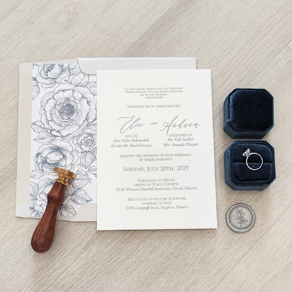 This is a letterpress wedding invitation printed in a charcoal ink paired with a pale grey envelope with floral envelope liner.