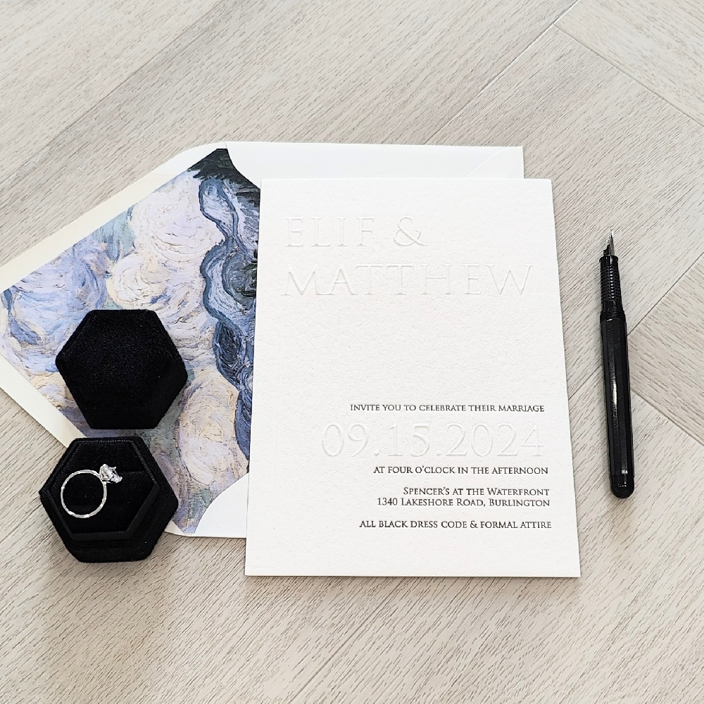 This is a letterpress wedding invite that also has raised blind embossing.  It is paired with an off white envelope that has a custom floral envelope liner.