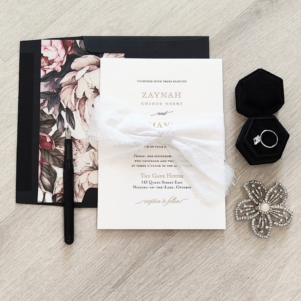 Single card wedding invite with a lace know tied around with a black envelope and envelope liner.