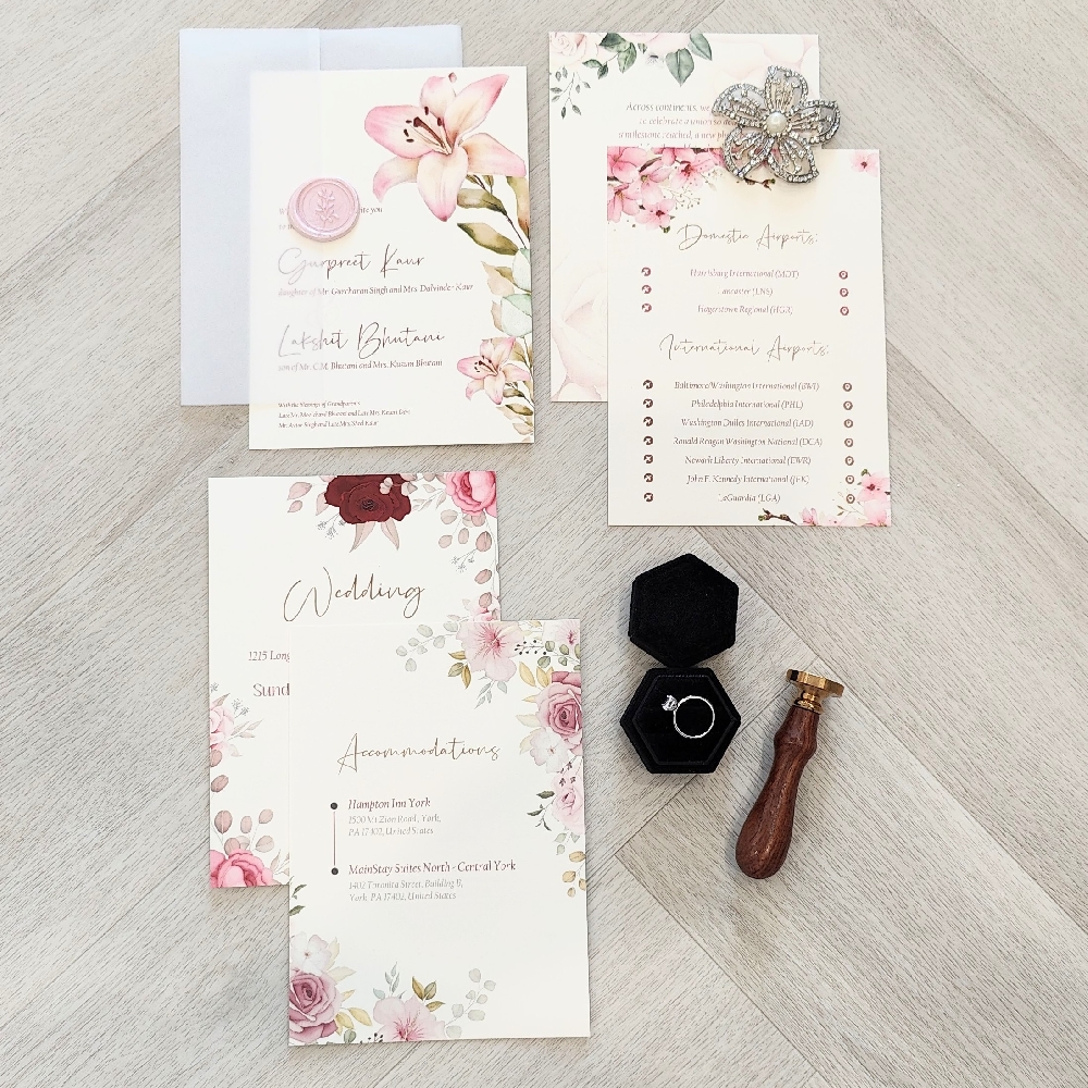 Multiple inserts into a vellum wrap enclosure and pink wax seal design.