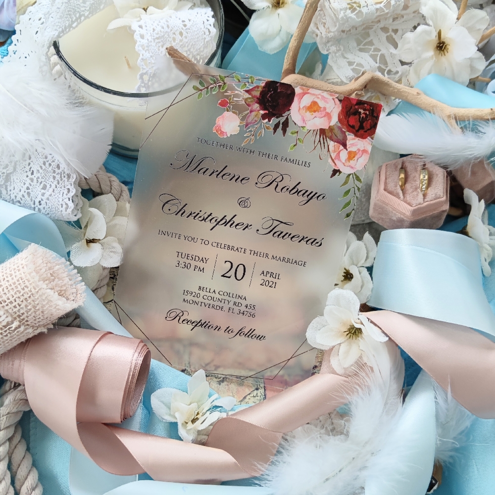 Frosted acrylic invitations are a beautiful option for something modern and unique but you can keep the print traditional with florals and font to maintain an elegant sleek look.