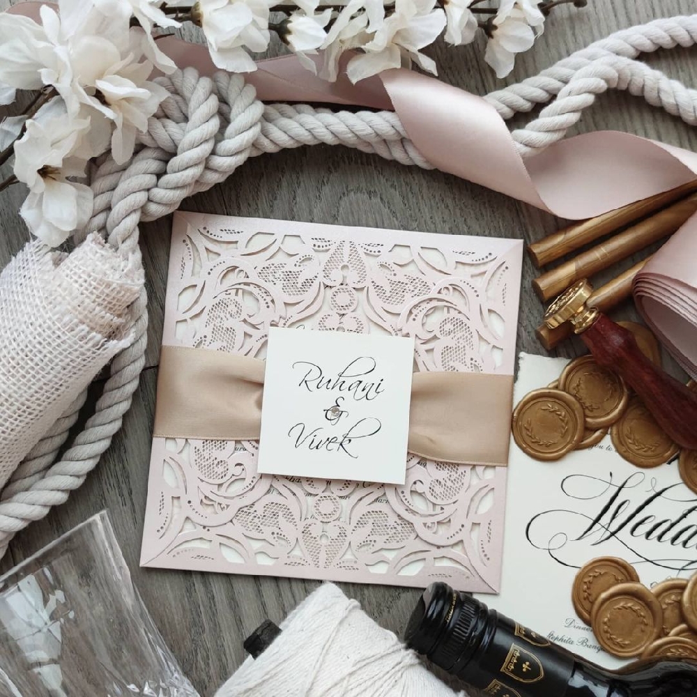 Classic blush tones on a lasercut invitation creates a soft elegant look.