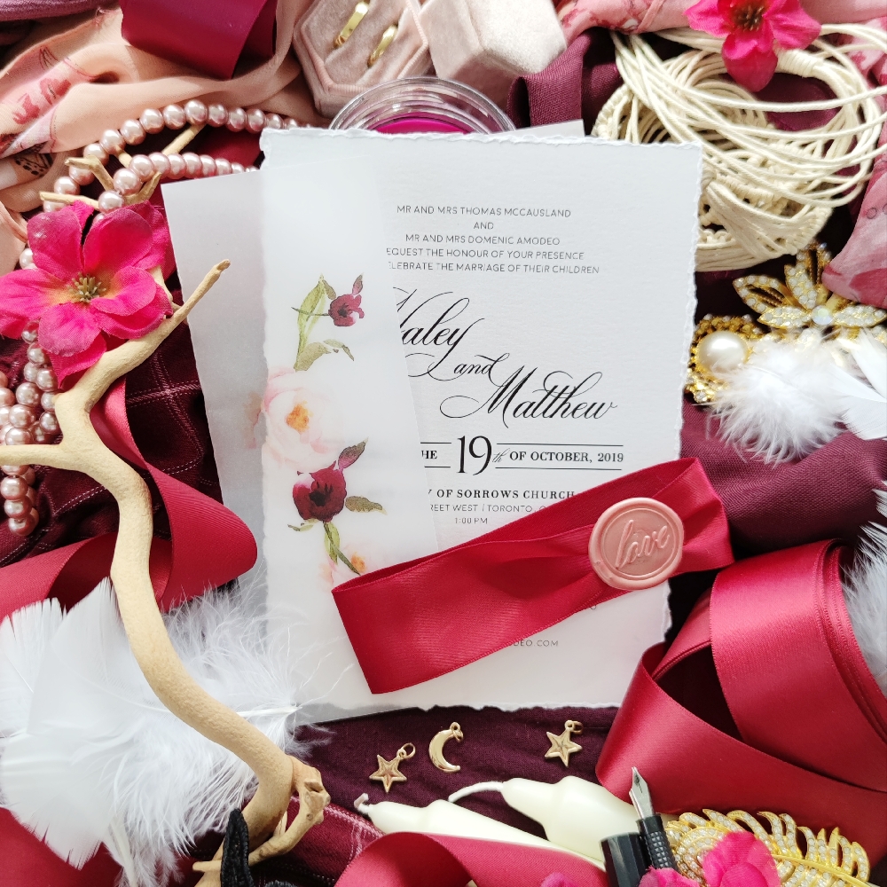 This deckle edge or torn edge wedding invitation is beautifully accented with ribbon and wax seal. For more options contact us and speak with a design consultant over the phone.