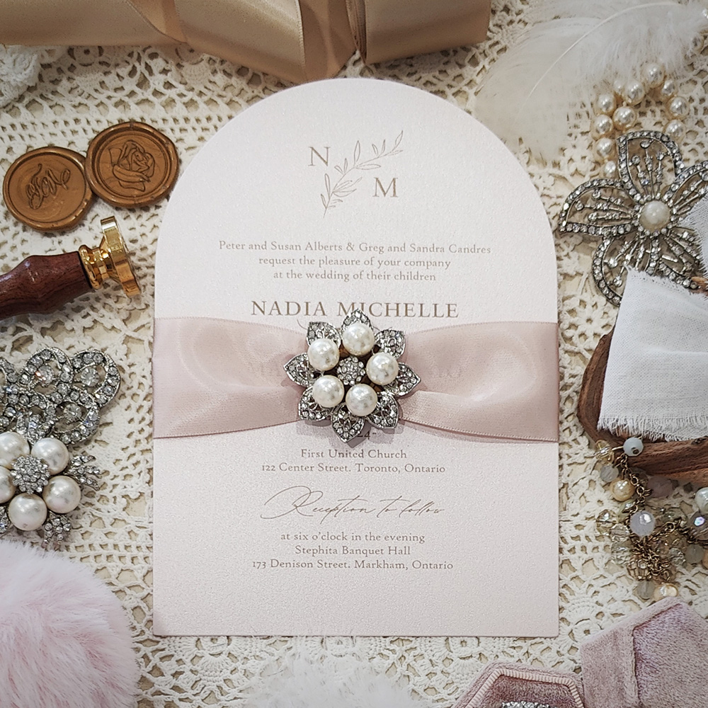 Invitation 3609: White Gold, Deep Blush Ribbon, Brooch/Buckle T - White gold arch shaped wedding card with a blush ribbon and a 5 pearl brooch.