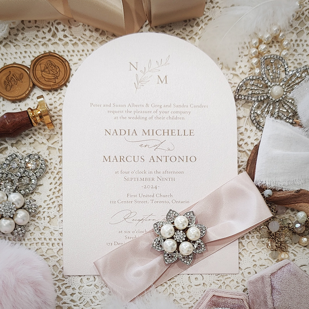 Invitation 3609: White Gold, Deep Blush Ribbon, Brooch/Buckle T - White gold arch shaped wedding card with a blush ribbon and a 5 pearl brooch.