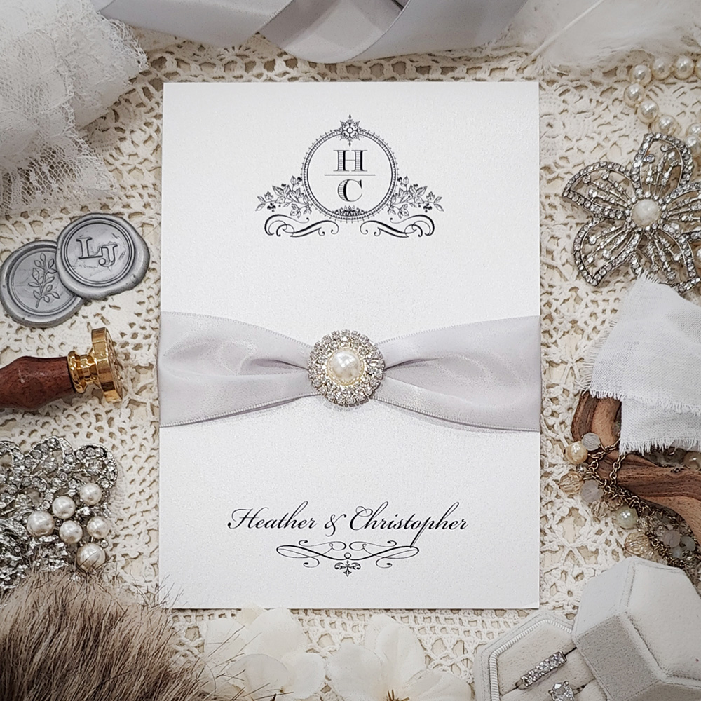 Invitation 3510: Ice Pearl, Silver Ribbon, Brooch/Buckle G - Pocketfolder on ice pearl paper with a silver ribbon and pearl brooch.