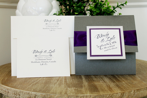 Invitation 1504: This square pocketfold invite has three layers of paper for the cover tag and a thick ribbon pinched behind the tag.  We print on cream paper and the folder is in charcoal pearl.