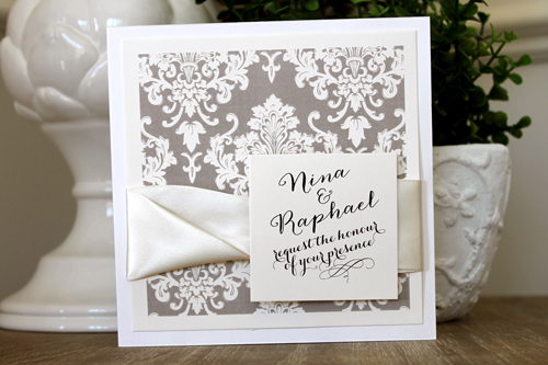 Invitation 1507: This square invite opens like a book and has a Champagne printed damask pattern on the cover.  Two antique ribbons are twisted together to create a nice thick ribbon detail.