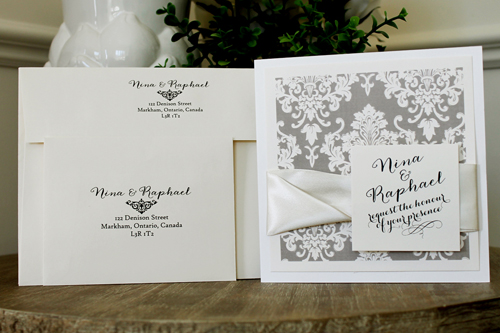 Invitation 1507: This square invite opens like a book and has a Champagne printed damask pattern on the cover.  Two antique ribbons are twisted together to create a nice thick ribbon detail.