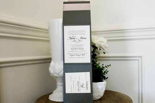 Invitation 1508: Charcoal Pearl, Blush Pearl, Cream Smooth, Deep Blush Ribbon - This three fold invite opens with a pocket at the bottom.  The ribbon is pinched with a large tag in the centre.